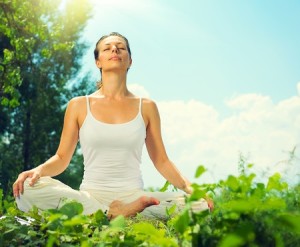 31397649 - young woman doing yoga exercises outdoors